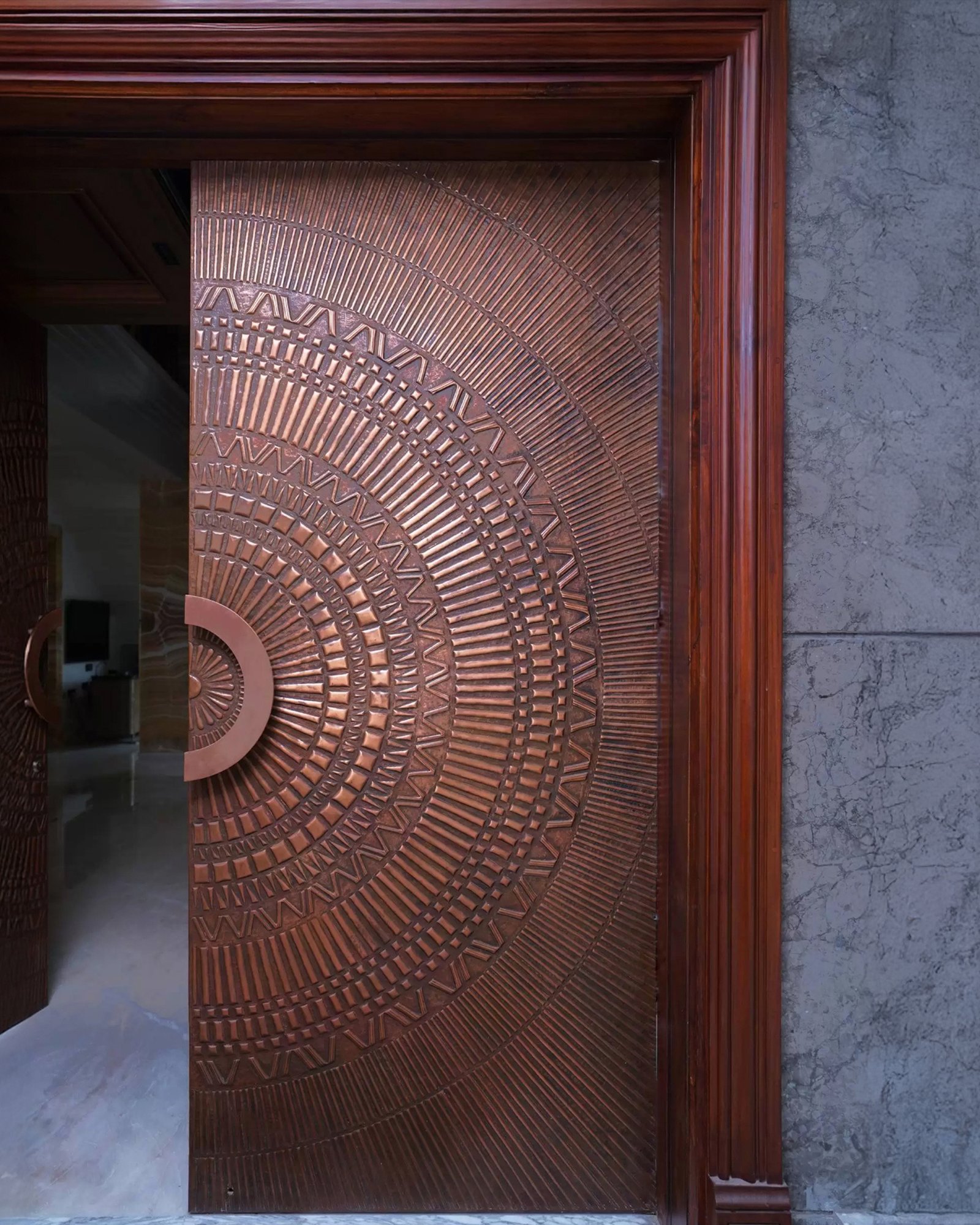Delta brass door with triangular geometric pattern